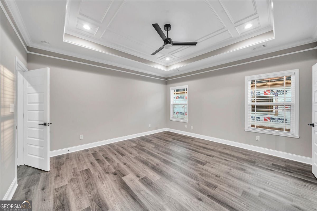 212 Eric Court Byron, GA 31008 - Photo 19 of 37 a view of an empty room with wooden floor and a window