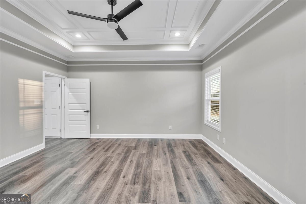 212 Eric Court Byron, GA 31008 - Photo 20 of 37 a view of an empty room with a window and wooden floor