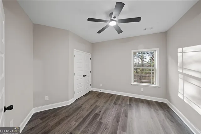 wooden floor in an empty room with a window