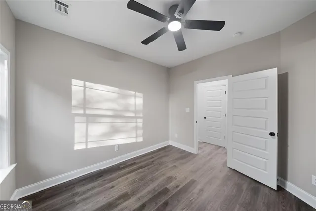 wooden floor in an empty room with a window