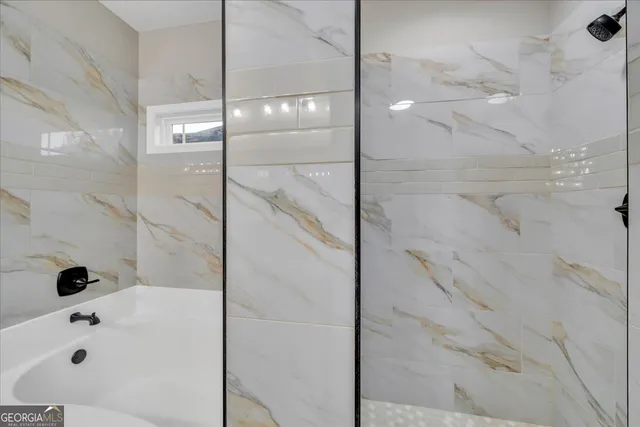 a bathroom with a bathtub and shower