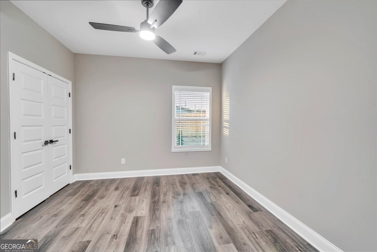 212 Eric Court Byron, GA 31008 - Photo 26 of 37 wooden floor in an empty room with a window