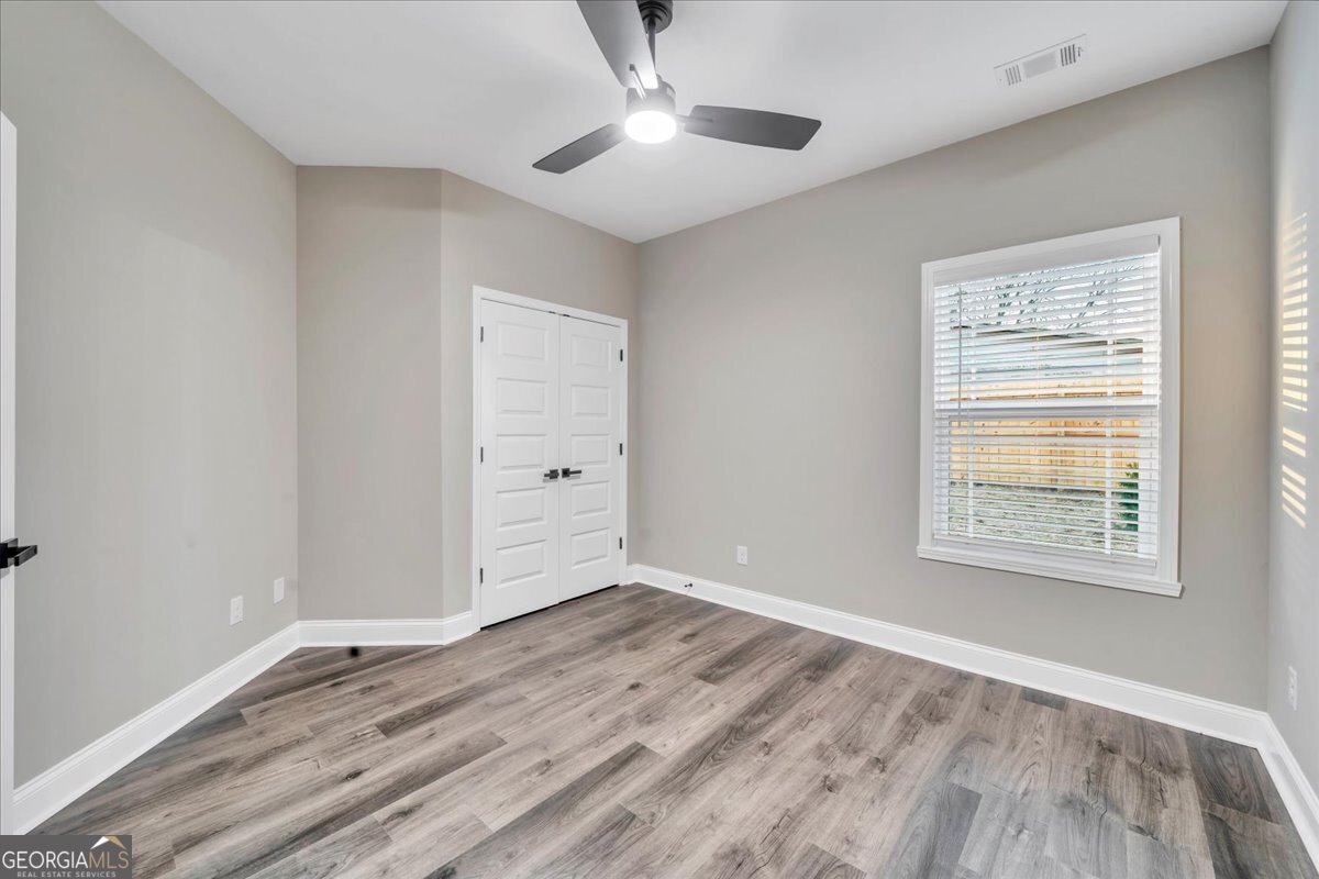 212 Eric Court Byron, GA 31008 - Photo 27 of 37 a view of empty room with wooden floor and fan