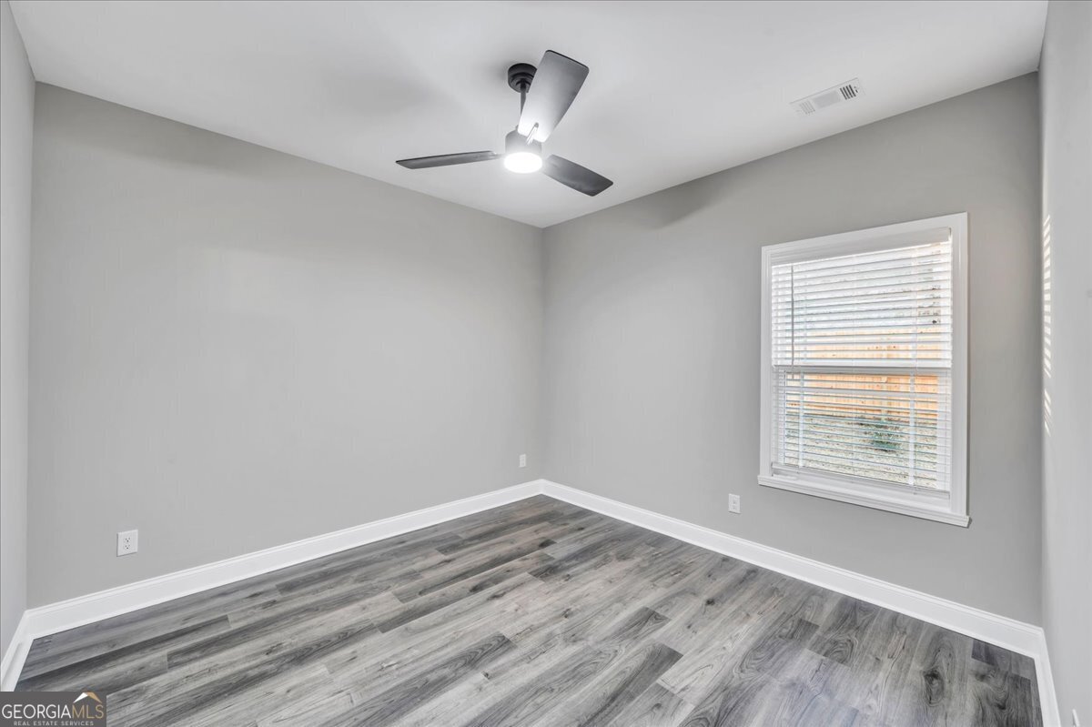 212 Eric Court Byron, GA 31008 - Photo 28 of 37 wooden floor in an empty room with a window