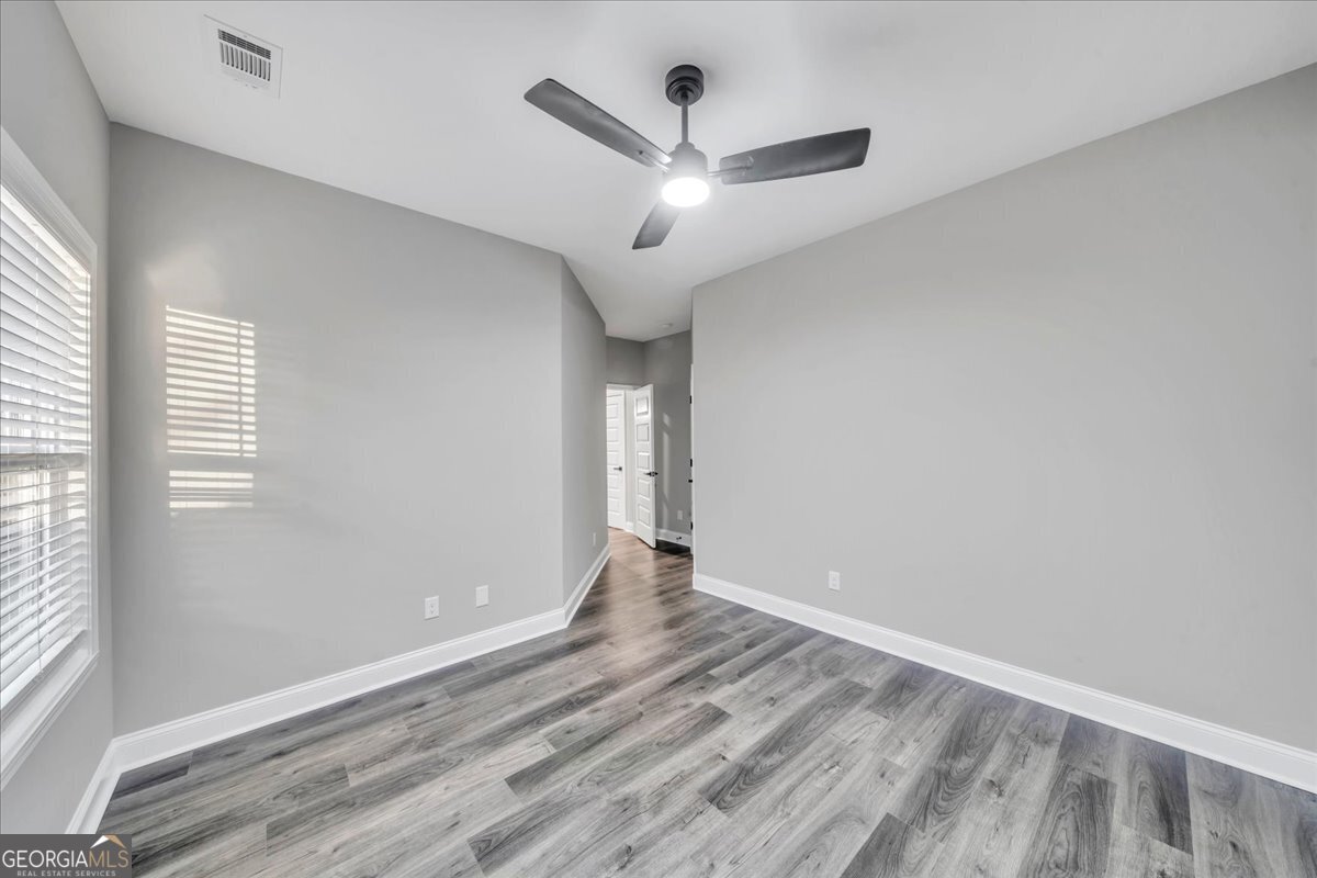 212 Eric Court Byron, GA 31008 - Photo 29 of 37 wooden floor in an empty room with a window