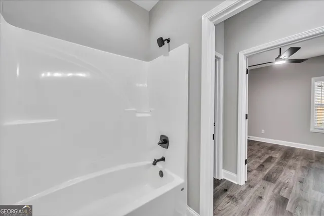 a bathroom with a bathtub and a shower