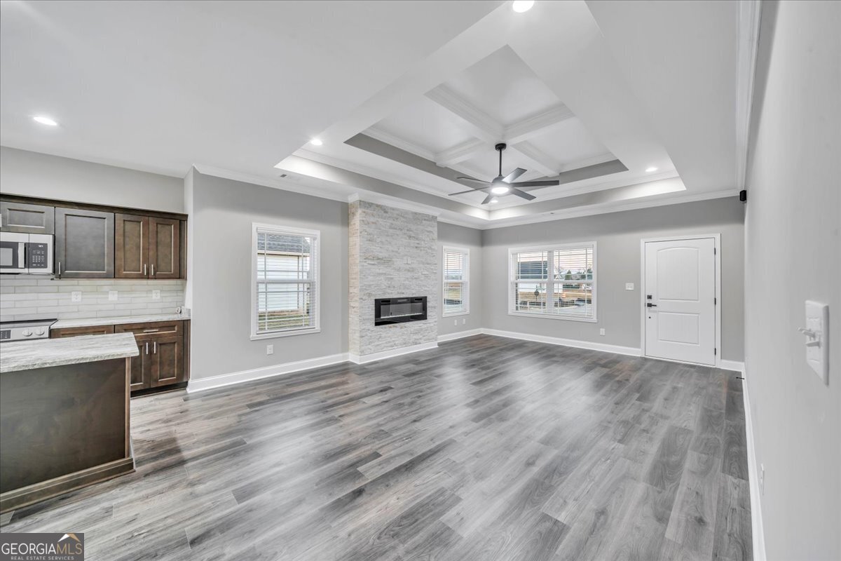 212 Eric Court Byron, GA 31008 - Photo 5 of 37 a view of an empty room with a fireplace and a window
