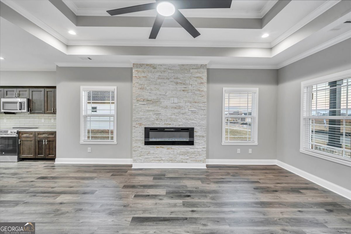 212 Eric Court Byron, GA 31008 - Photo 6 of 37 a view of an empty room with a fireplace and a window