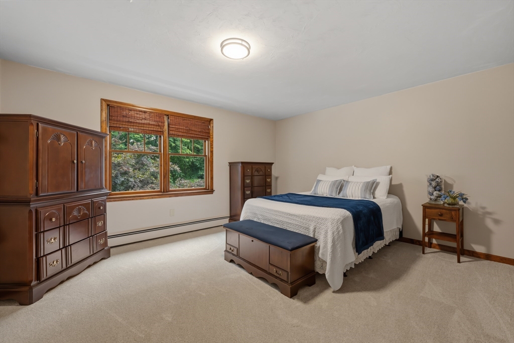 14 Demond Pond Row Rutland, MA 01543 - Photo 24 of 42 a spacious bedroom with a bed and wooden floor