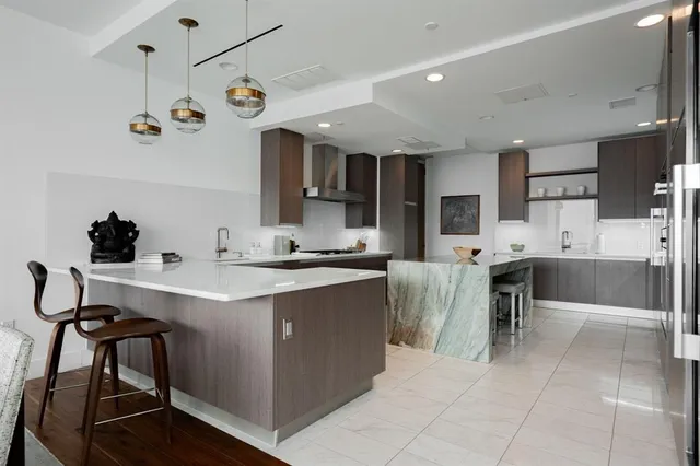 a kitchen with a sink a counter top space appliances and cabinets