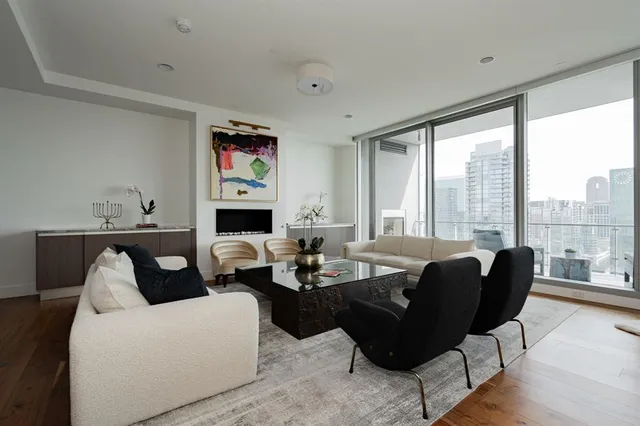 a living room with furniture and large windows