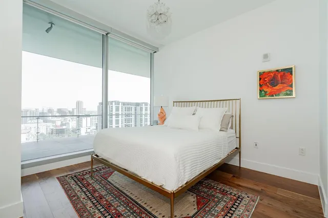 a bed sitting in a bedroom next to a window