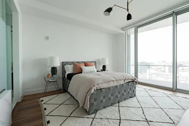 a bedroom with a bed and a large window