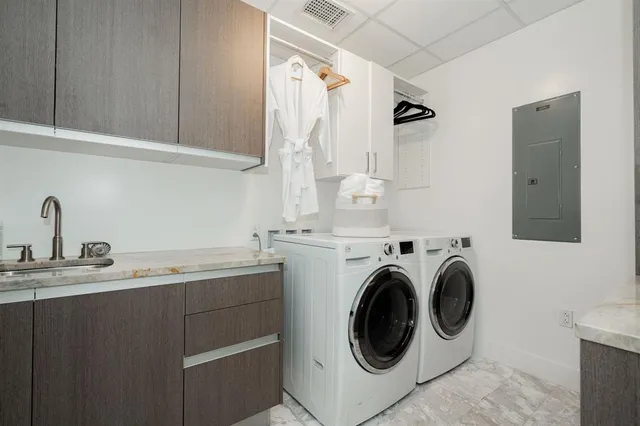 a utility room with sink dryer and washer
