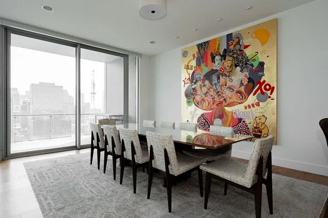 a dining room with furniture a large window and a rug