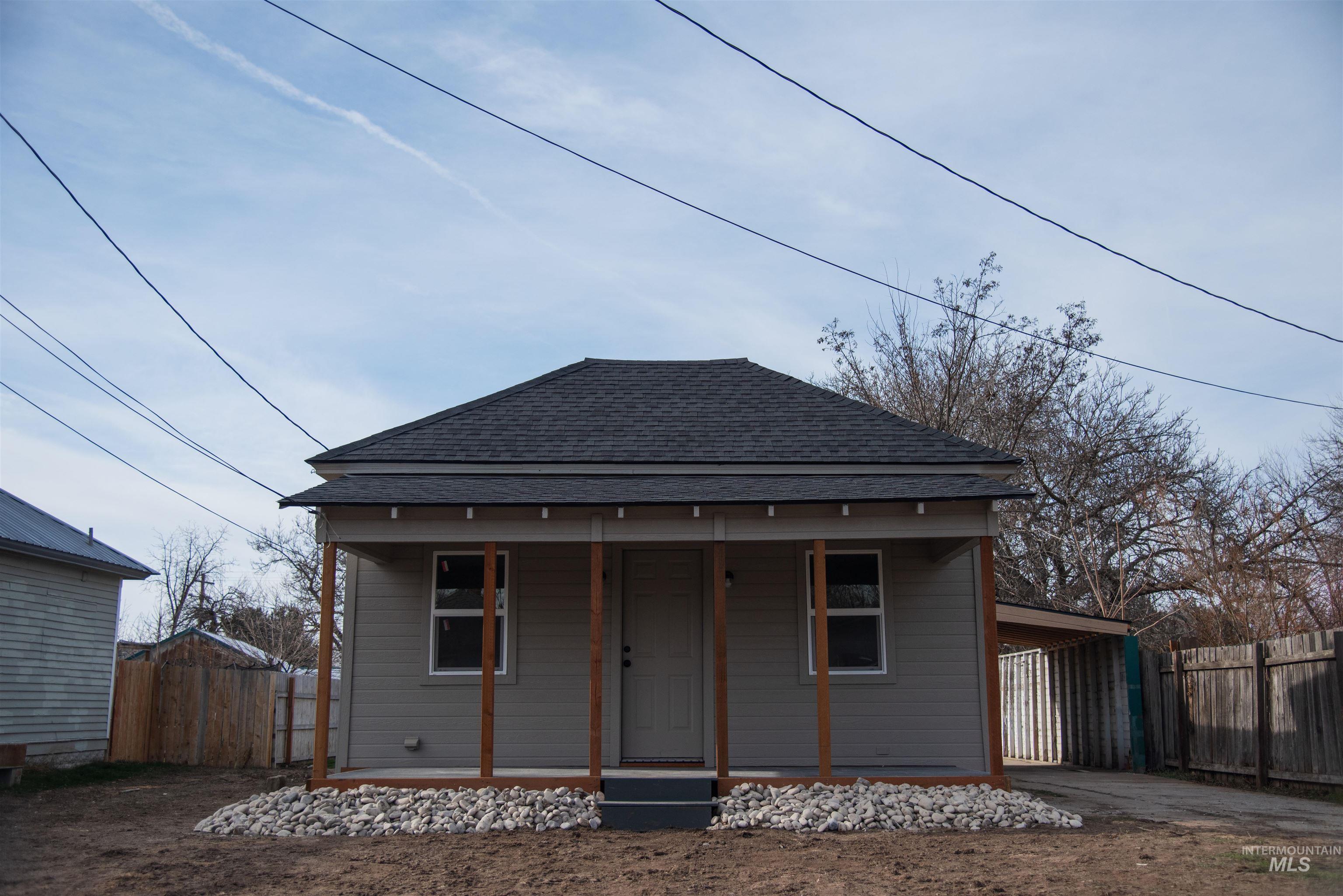 907 North 7th Street Payette, ID 83661 - Photo 1 of 15 Back of house with roof with shingles, concrete driveway, an attached carport, and covered porch