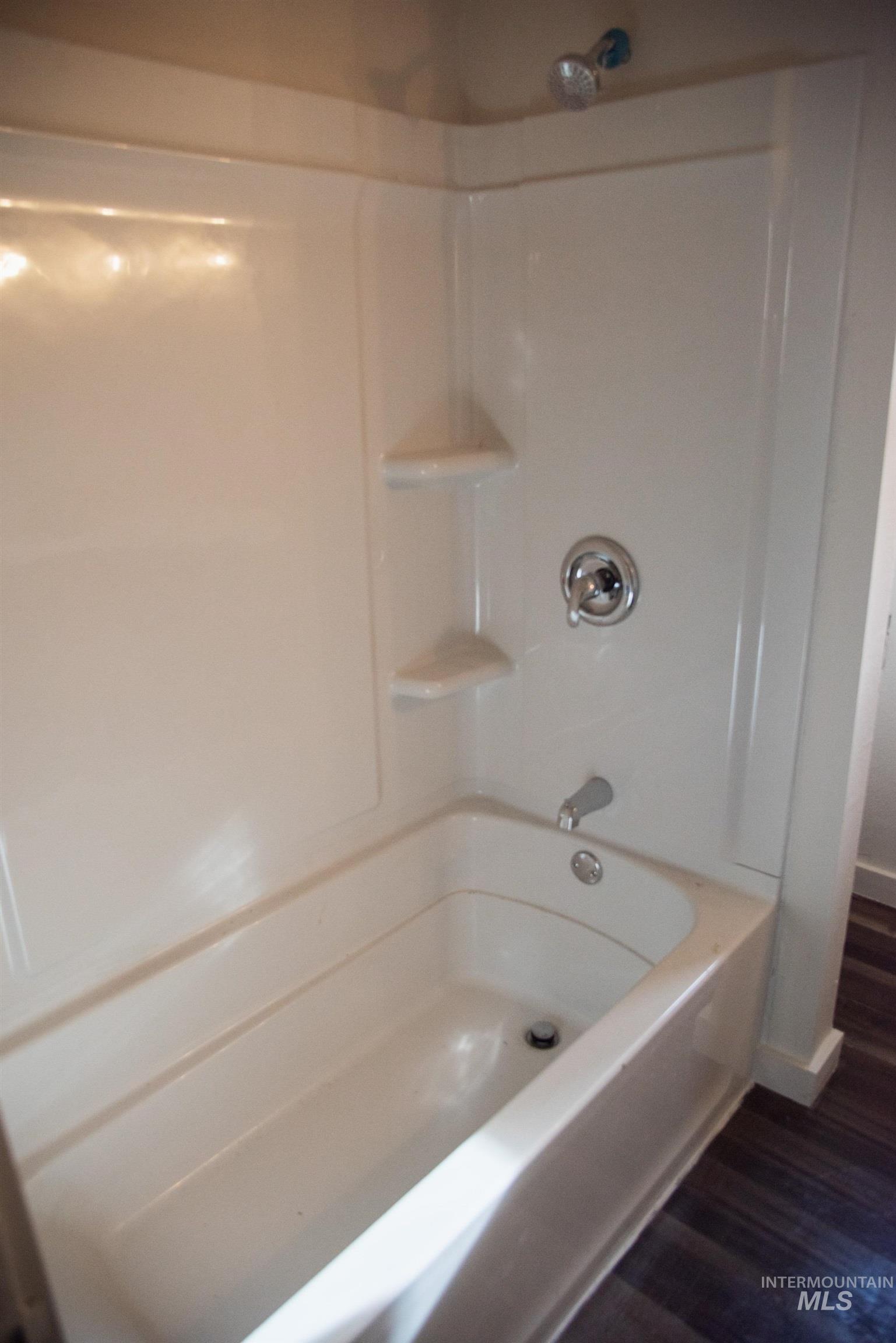 907 North 7th Street Payette, ID 83661 - Photo 7 of 15 Full bathroom featuring washtub / shower combination and dark wood-style floors