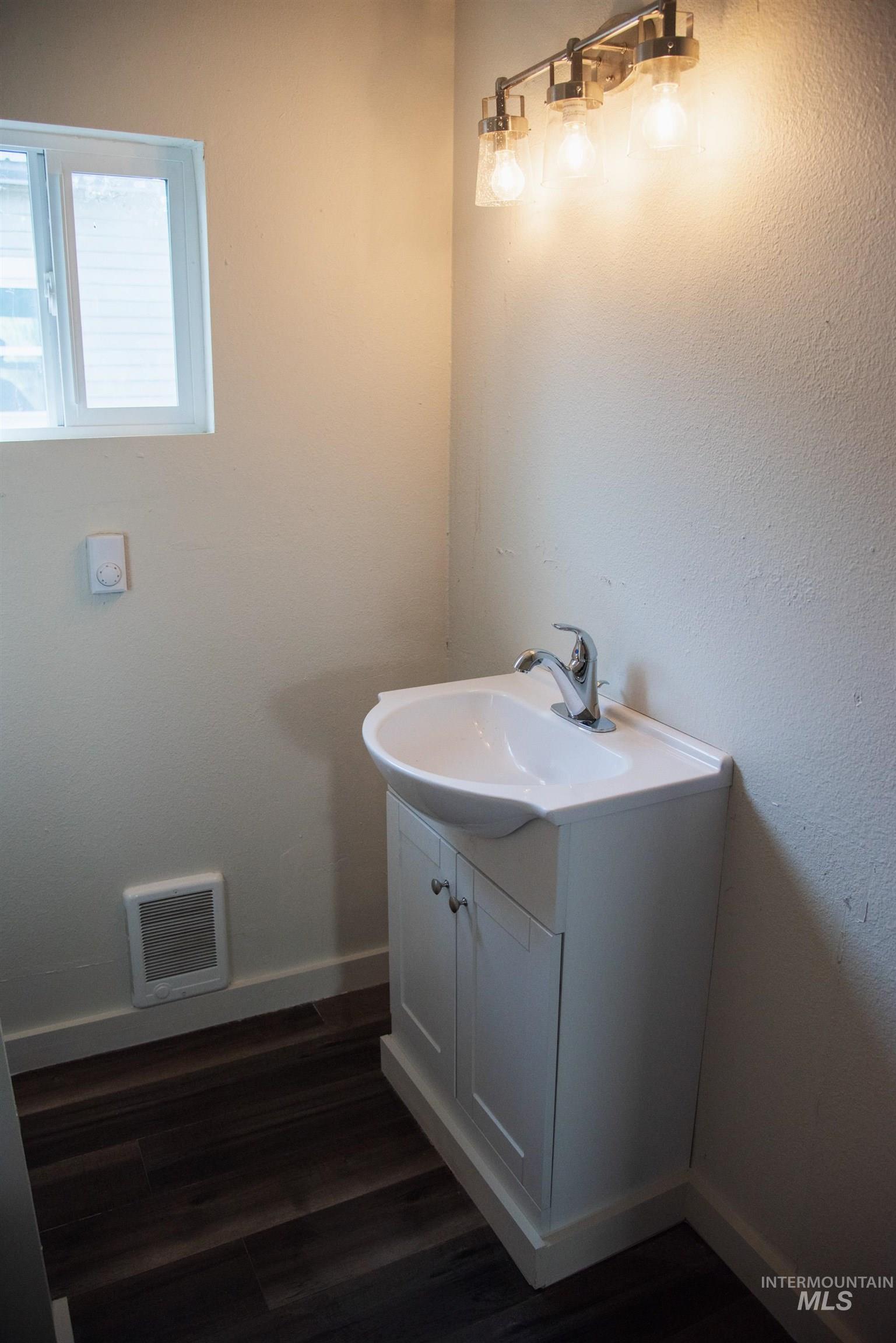 907 North 7th Street Payette, ID 83661 - Photo 8 of 15 Bathroom with vanity and dark wood-style flooring