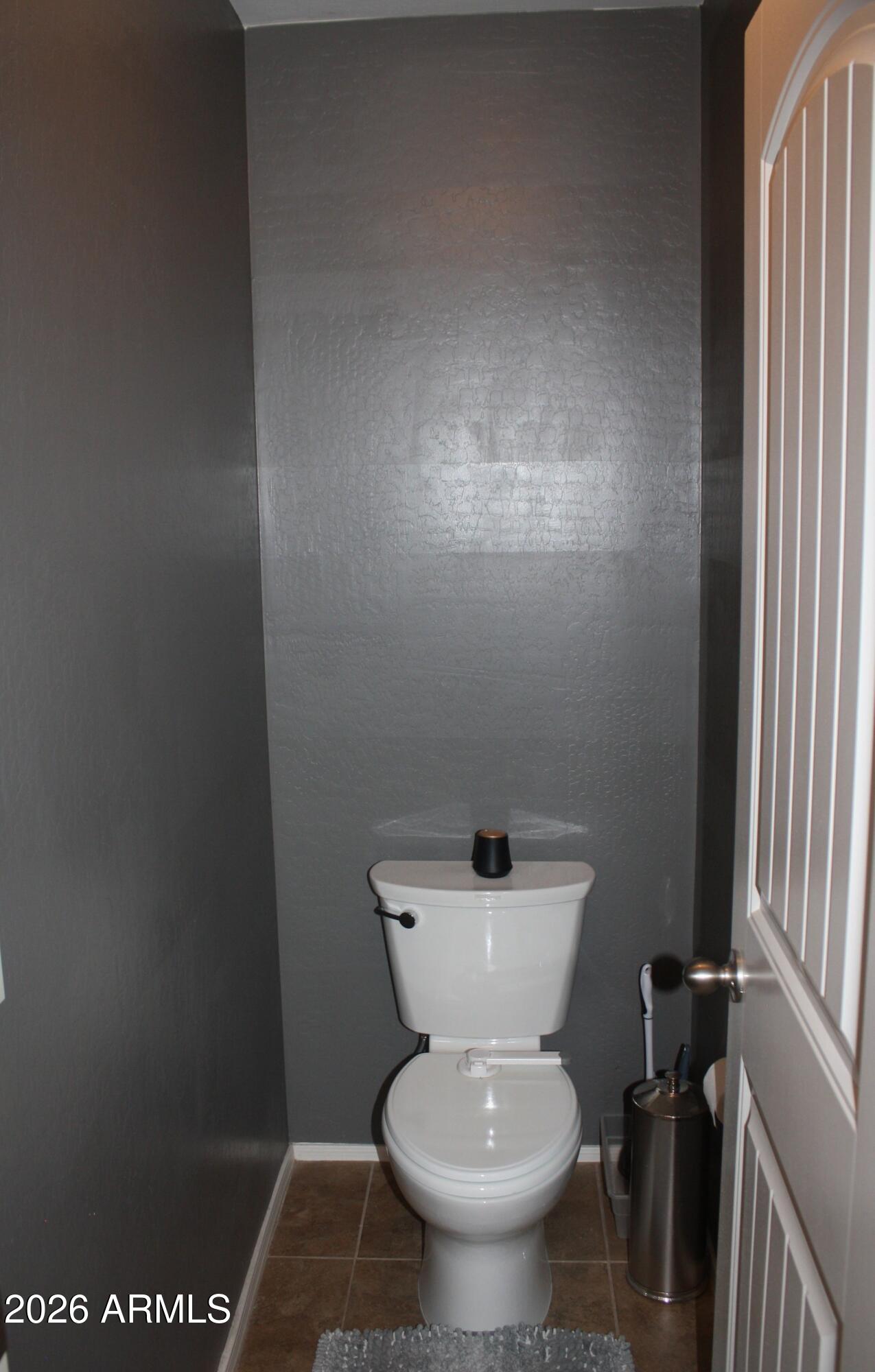 10225 West Camelback Road, Unit 19 Phoenix, AZ 85037 - Photo 37 of 51 a white toilet sitting next to a window