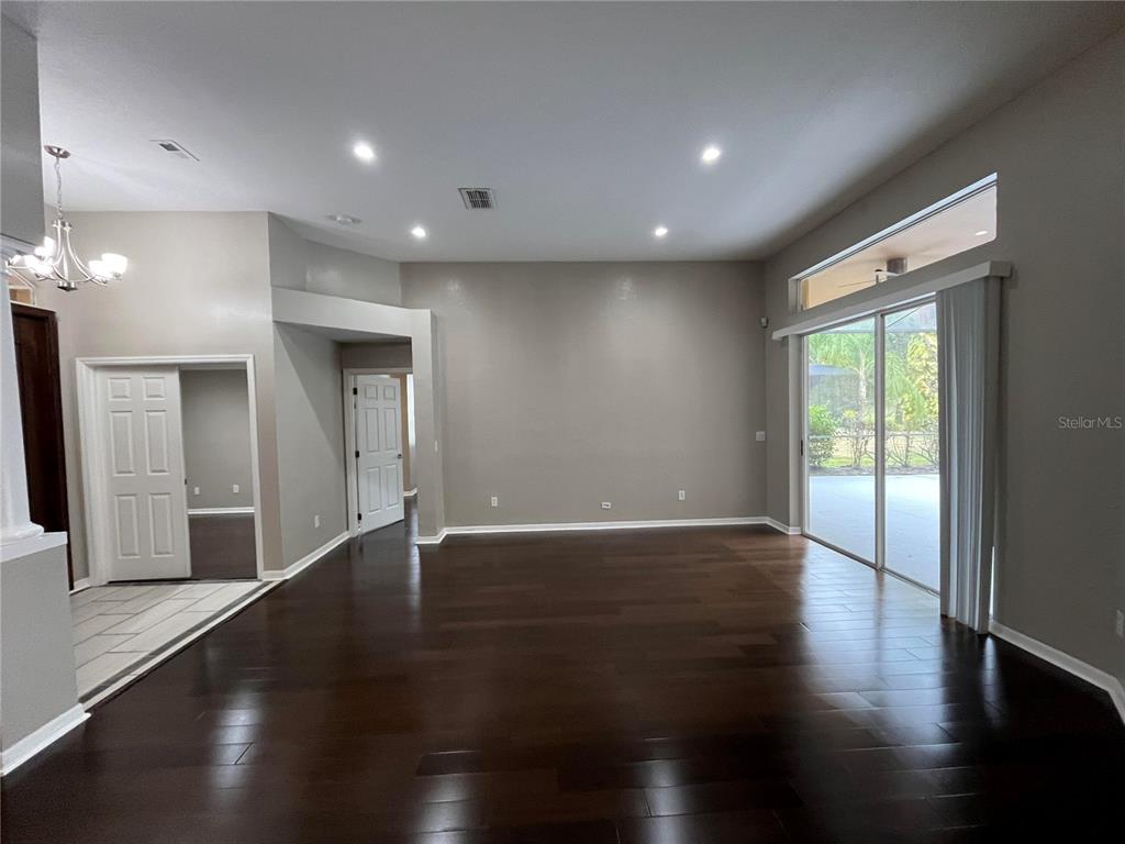 2533 Ridgewind Way Windermere, FL 34786 - Photo 11 of 33 an empty room with wooden floor and windows