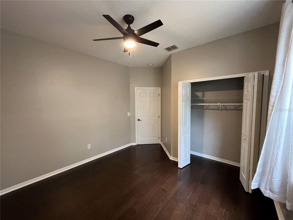 2533 Ridgewind Way Windermere, FL 34786 - Photo 15 of 33 an empty room with wooden floor and a ceiling fan