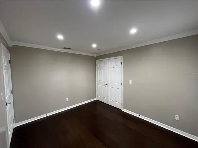 an empty room with wooden floor