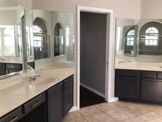 a bathroom with a double vanity sink and a mirror