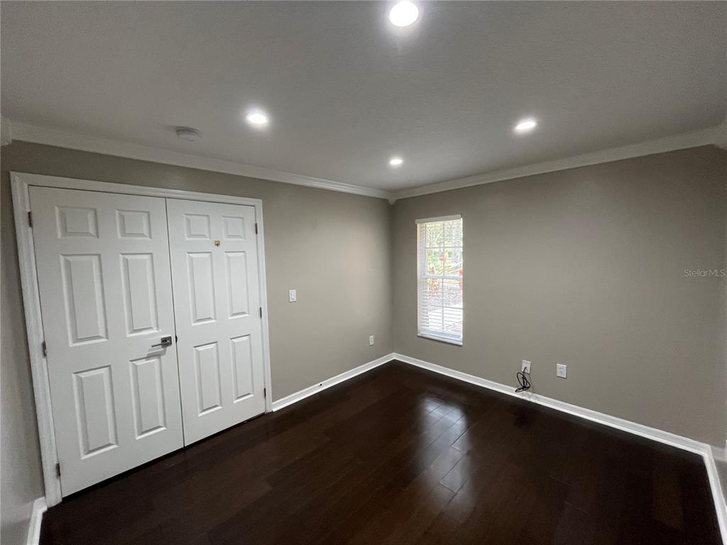 2533 Ridgewind Way Windermere, FL 34786 - Photo 17 of 33 an empty room with wooden floor and windows