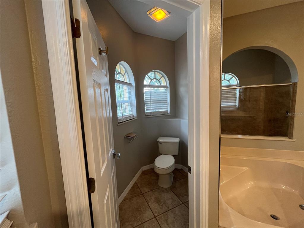 2533 Ridgewind Way Windermere, FL 34786 - Photo 23 of 33 a bathroom with a toilet and a shower