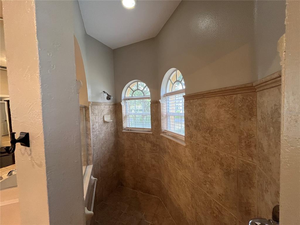 2533 Ridgewind Way Windermere, FL 34786 - Photo 24 of 33 a view of a livingroom with wooden floor and a bathroom