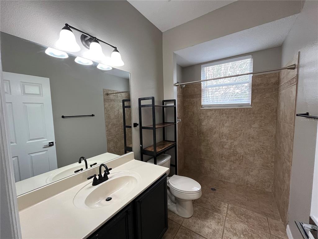 2533 Ridgewind Way Windermere, FL 34786 - Photo 27 of 33 a bathroom with a sink mirror vanity and toilet
