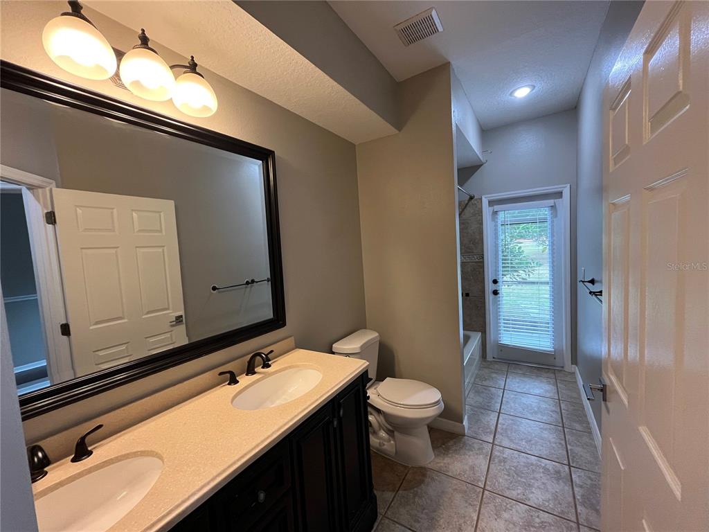 2533 Ridgewind Way Windermere, FL 34786 - Photo 28 of 33 a bathroom with a toilet sink and mirror