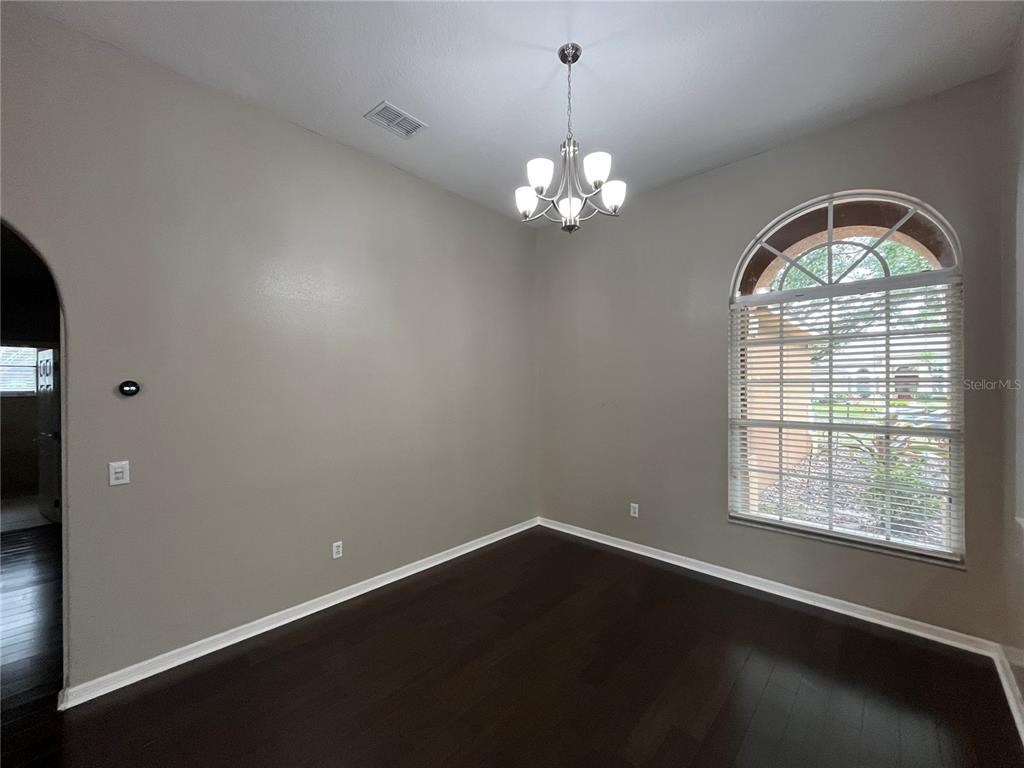 2533 Ridgewind Way Windermere, FL 34786 - Photo 5 of 33 wooden floor in an empty room with a window