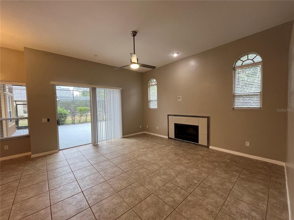2533 Ridgewind Way Windermere, FL 34786 - Photo 6 of 33 a view of an empty room with a fireplace and a window