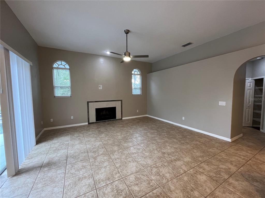 2533 Ridgewind Way Windermere, FL 34786 - Photo 7 of 33 an empty room with windows and fireplace