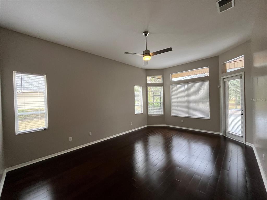 2533 Ridgewind Way Windermere, FL 34786 - Photo 9 of 33 a view of an empty room with wooden floor and a window