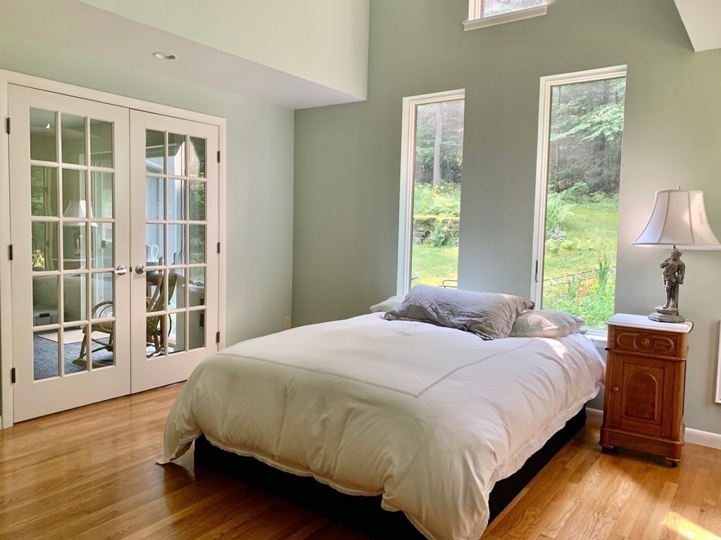 30 Butterhill Road Pelham, MA 01002 - Photo 23 of 39 a bedroom with a bed and wooden floor
