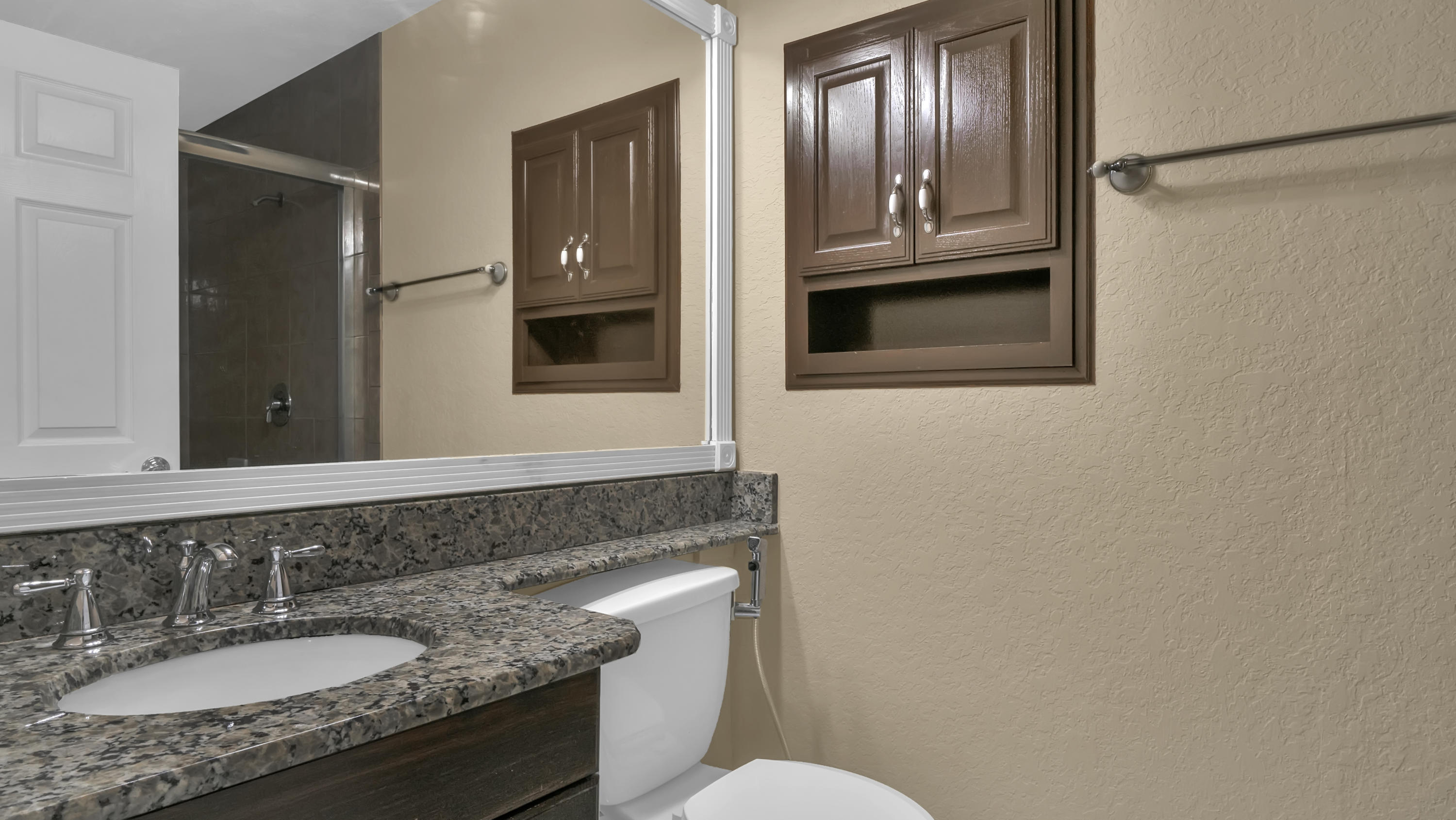 3765 Blue Ridge Road West Palm Beach, FL 33406 - Photo 11 of 15 a bathroom with a granite countertop sink toilet and mirror