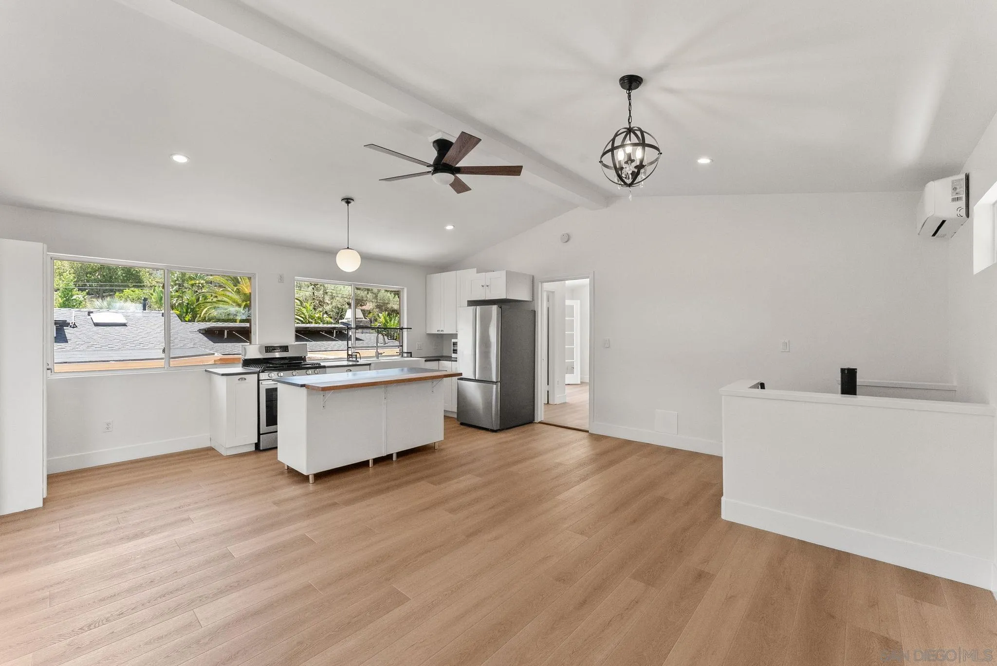 12832 Stone Canyon Road Poway, CA 92064 - Photo 38 of 60 a large white kitchen with a lot of cabinets and wooden floor