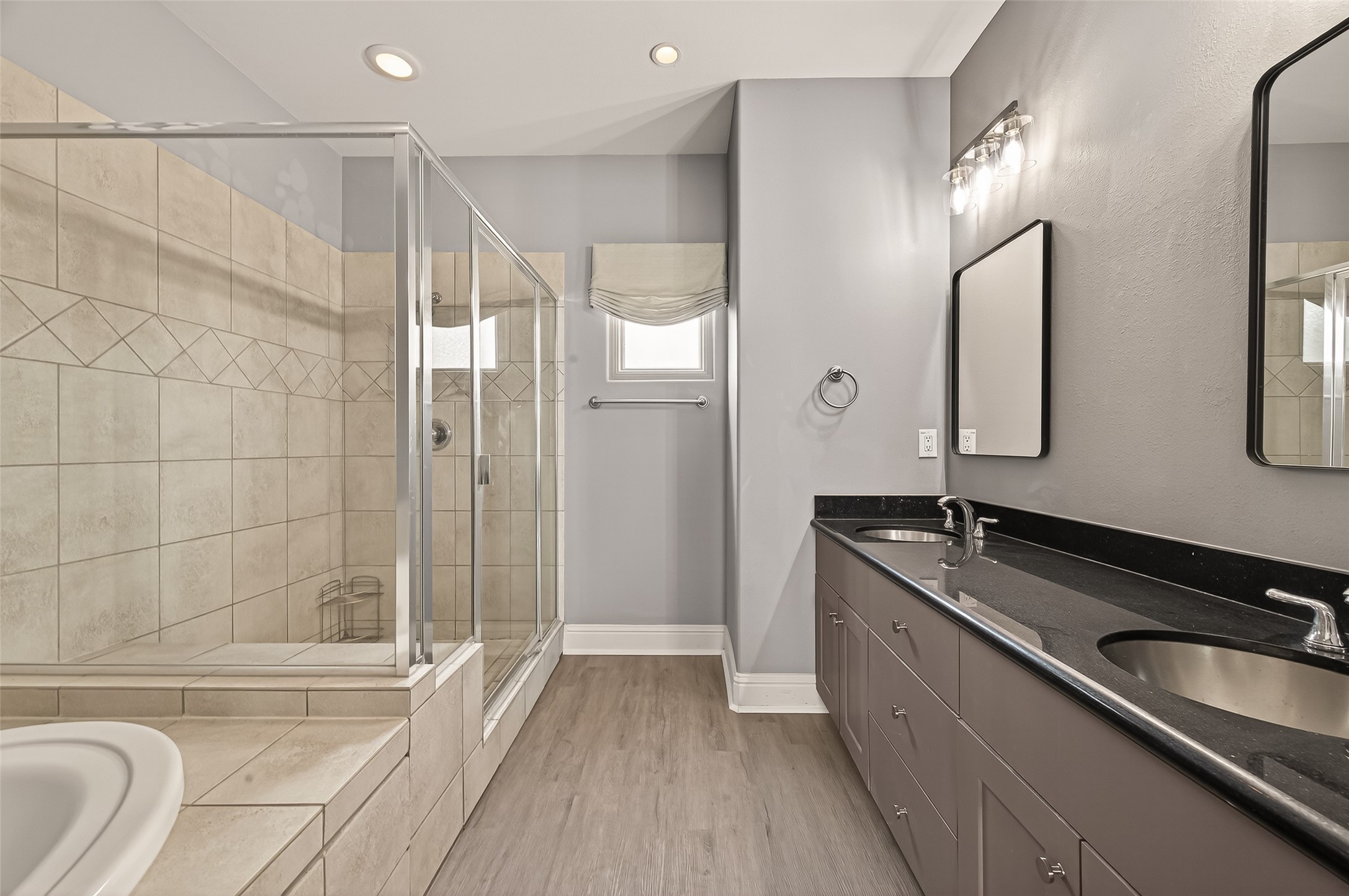 1107 St Charles Street Houston, TX 77003 - Photo 25 of 37 a bathroom with a granite countertop sink mirror toilet and bathtub