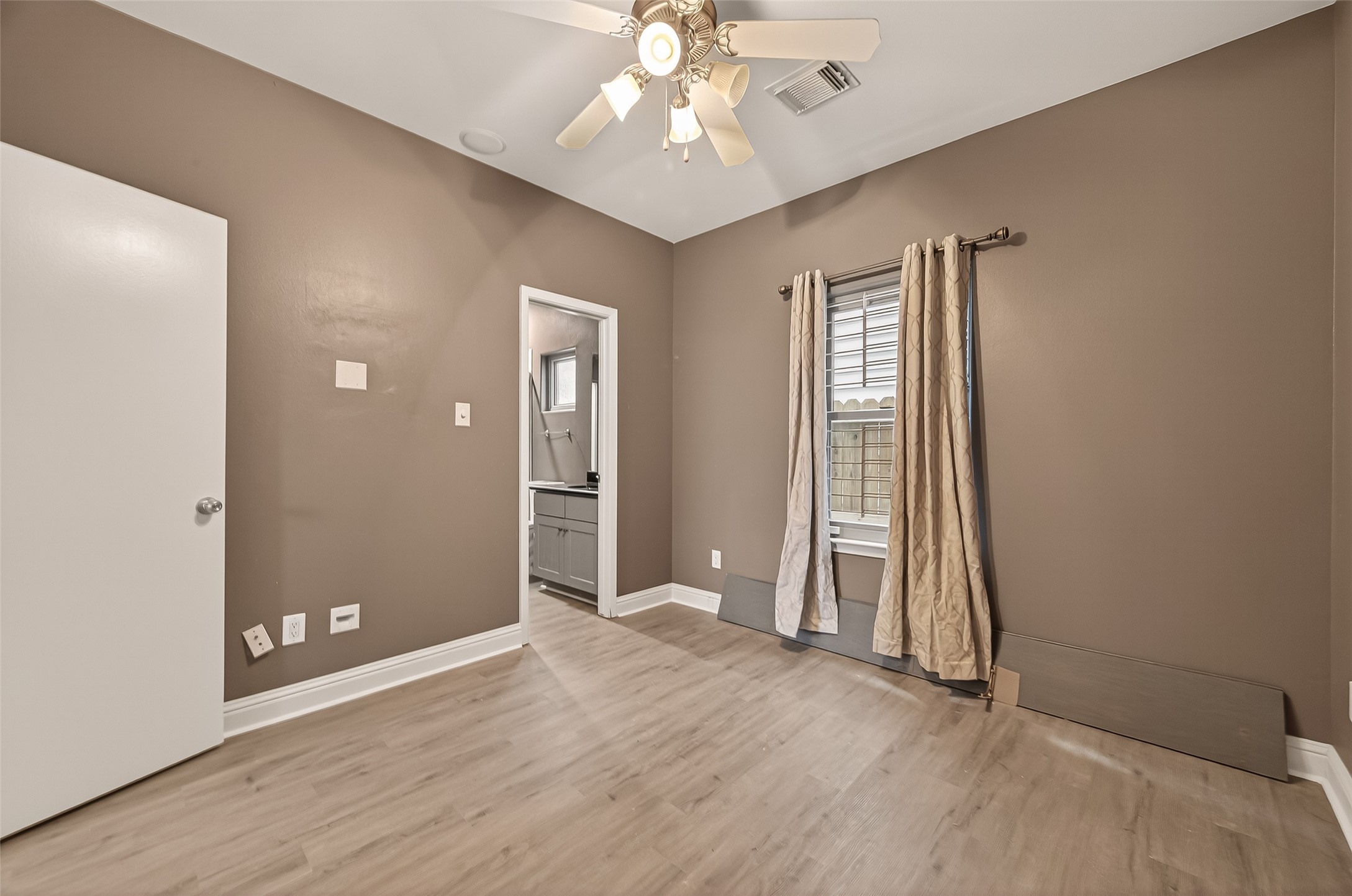 1107 St Charles Street Houston, TX 77003 - Photo 29 of 37 wooden floor in an empty room with a window