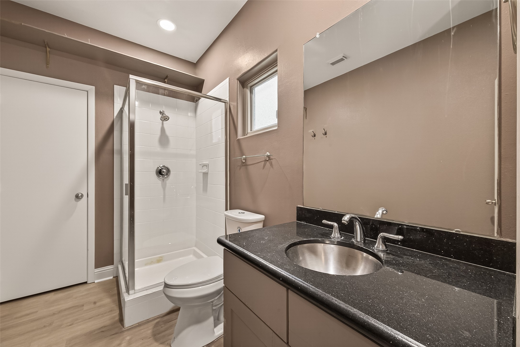 1107 St Charles Street Houston, TX 77003 - Photo 31 of 37 a bathroom with a granite countertop sink toilet and shower