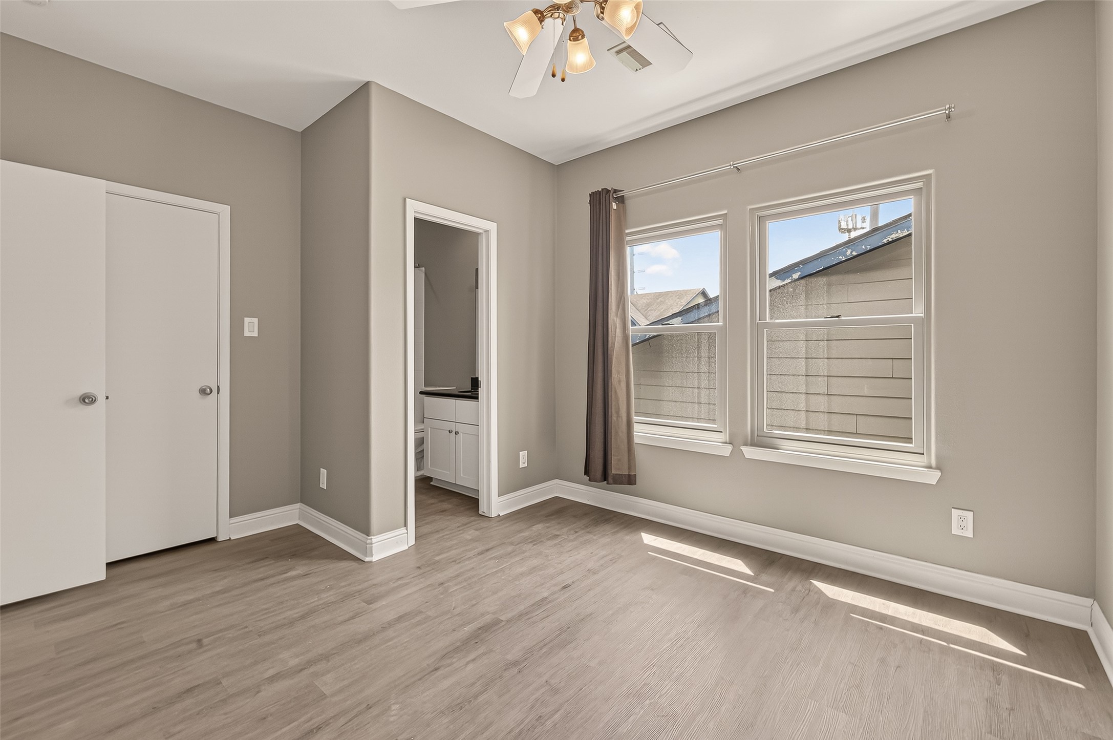 1107 St Charles Street Houston, TX 77003 - Photo 6 of 37 a view of an empty room with wooden floor and a window