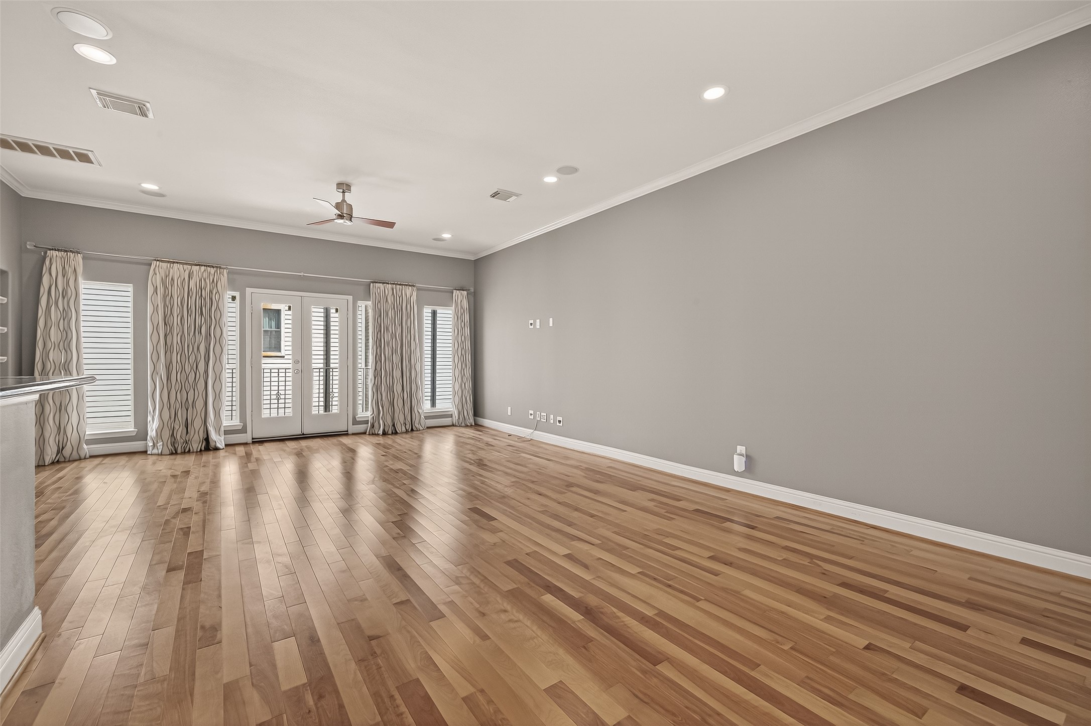 1107 St Charles Street Houston, TX 77003 - Photo 9 of 37 a view of an empty room with wooden floor and a window