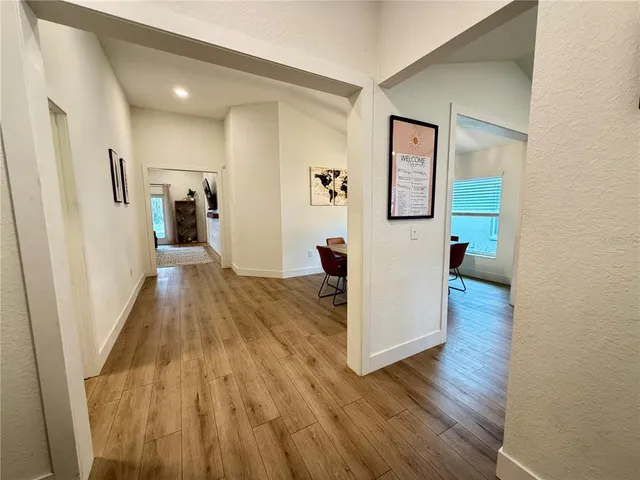 a view of a hallway view with wooden floor and staircase