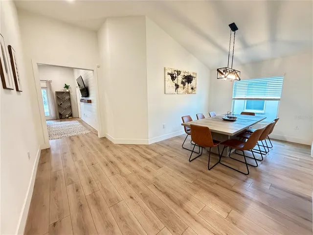a dining room with furniture and wooden floor