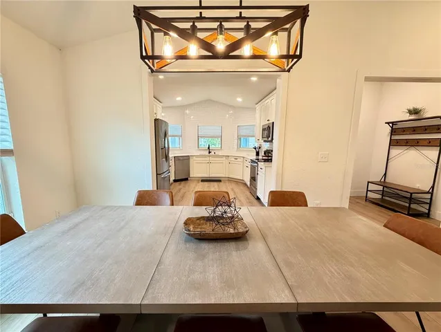 a bedroom with a bed a mirror and couch