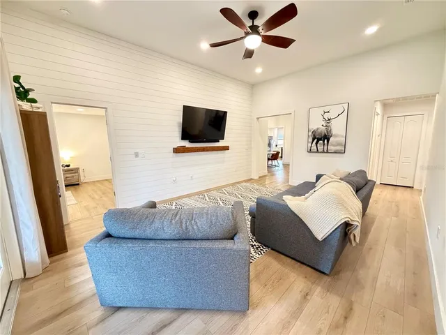 a living room with couches and a flat screen tv