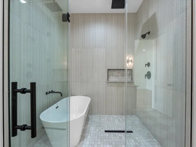 a bathroom with a bathtub and shower