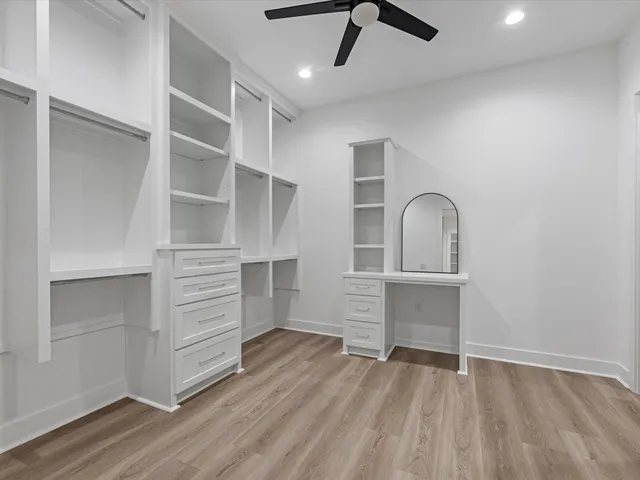 a view of walk in closet with empty racks
